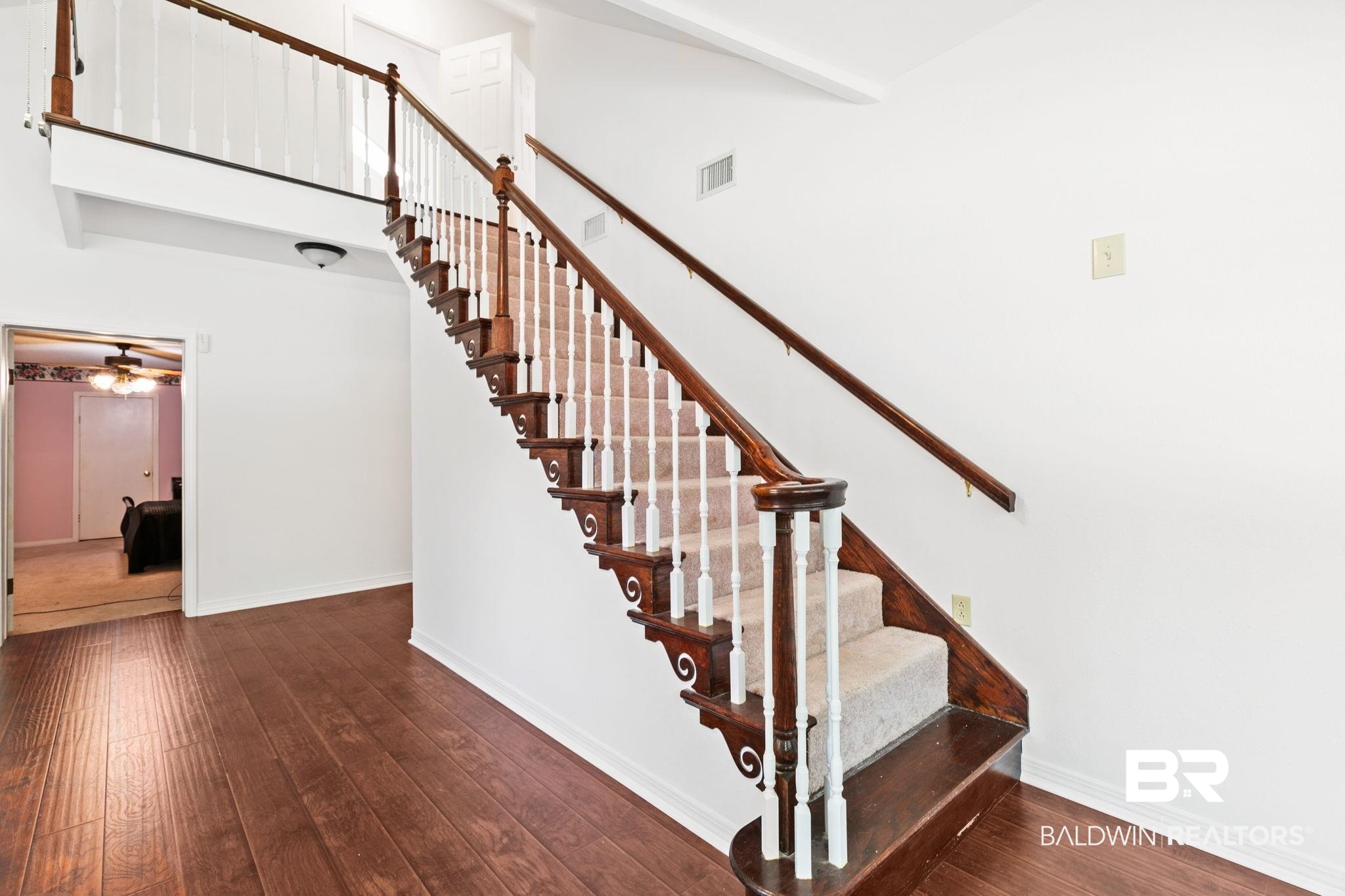 927 Cleveland Road Saraland, AL 36571 - Photo 39 of 80 Staircase featuring wood-finish railings, white balusters, and carpeted treads