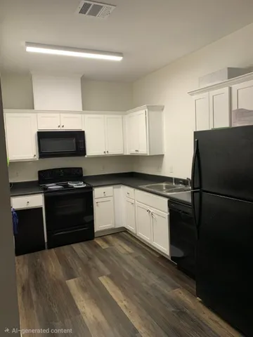 a kitchen with a refrigerator and a stove
