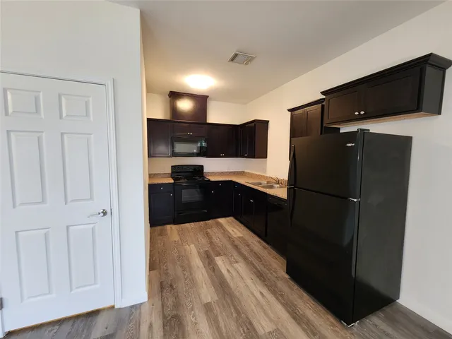 a kitchen with stainless steel appliances a refrigerator a stove a microwave and cabinets