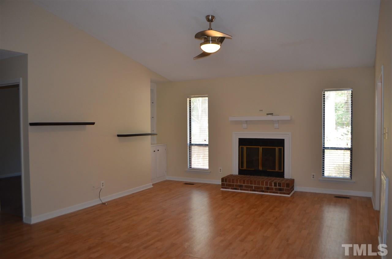 817 Horton Road Durham, NC 27704 - Photo 3 of 21 an empty room with windows and fireplace