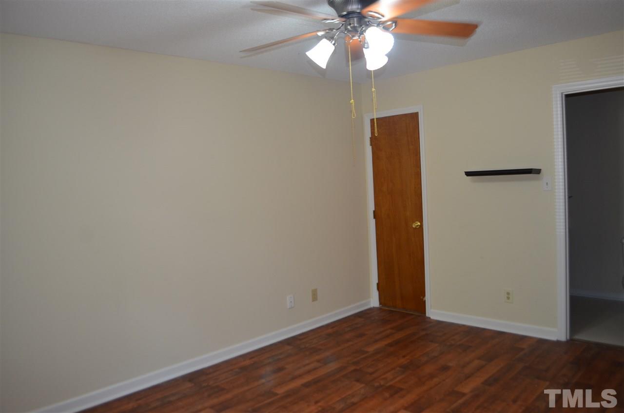 817 Horton Road Durham, NC 27704 - Photo 6 of 21 an empty room with wooden floor closet and fan