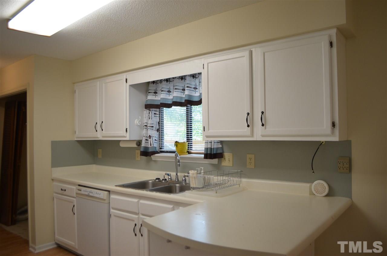 817 Horton Road Durham, NC 27704 - Photo 9 of 21 a kitchen with a sink cabinets and window