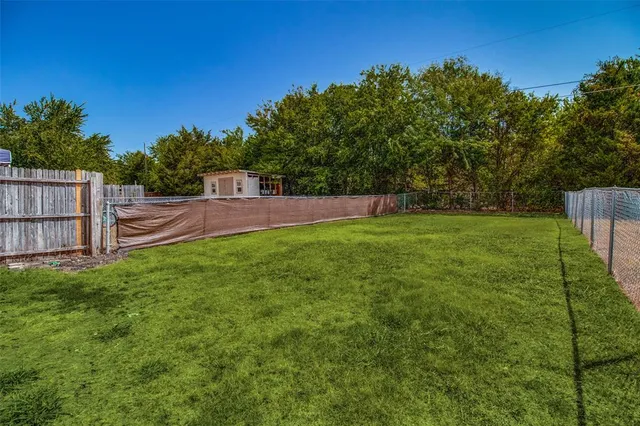 a view of a house with a yard and furniture