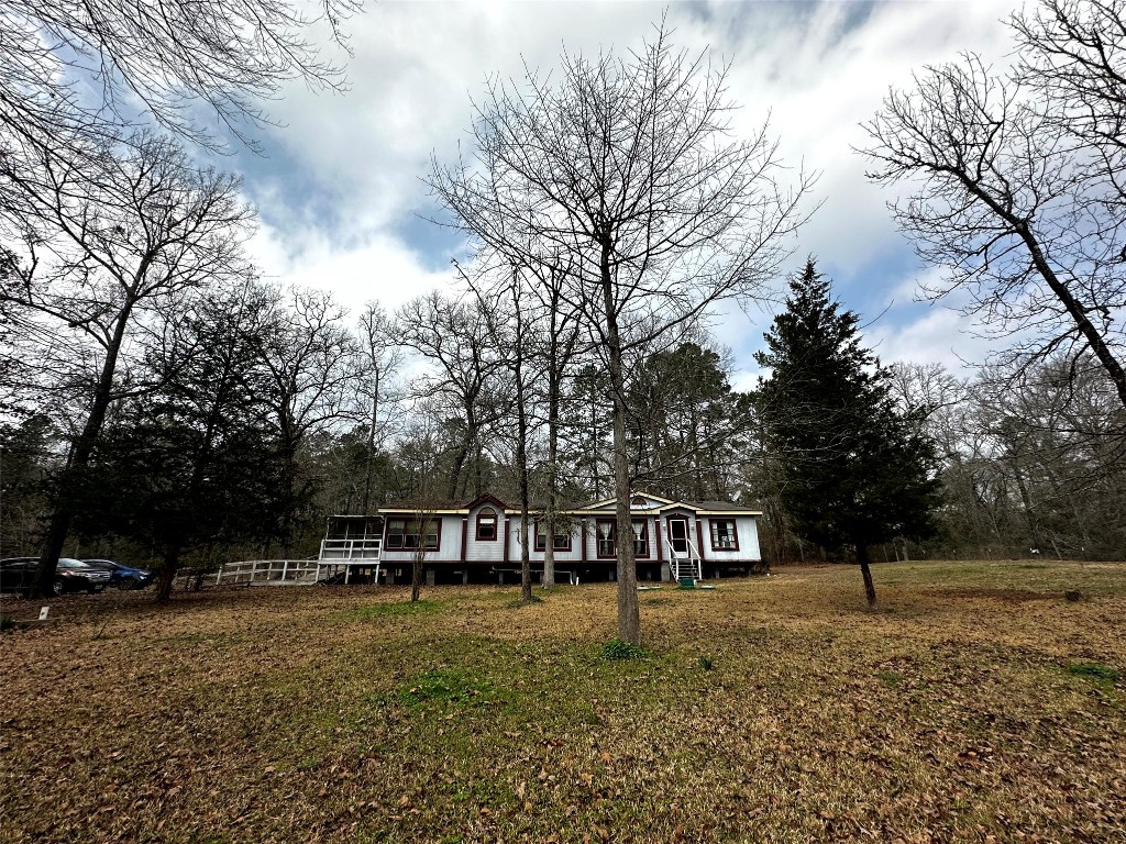 119 Cedar Frst Lane Corrigan, TX 75939 - Photo 1 of 32 a front view of a house with a yard