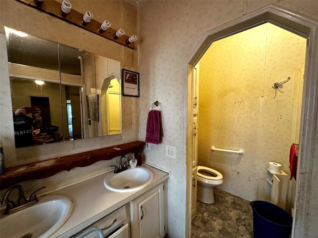 119 Cedar Frst Lane Corrigan, TX 75939 - Photo 21 of 32 a bathroom with a sink a toilet and a mirror