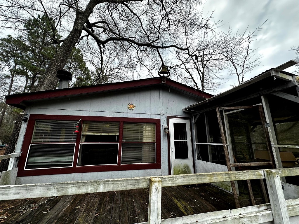 119 Cedar Frst Lane Corrigan, TX 75939 - Photo 22 of 32 a view of house with large windows and a small yard