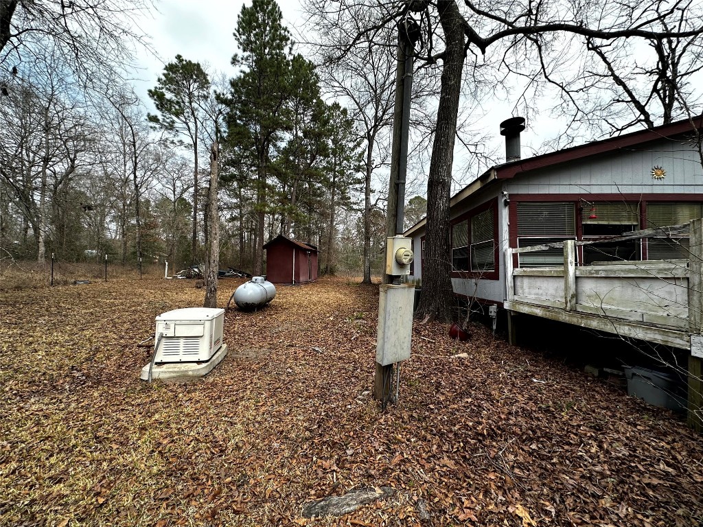 119 Cedar Frst Lane Corrigan, TX 75939 - Photo 25 of 32 a backyard of a house with a table and chairs