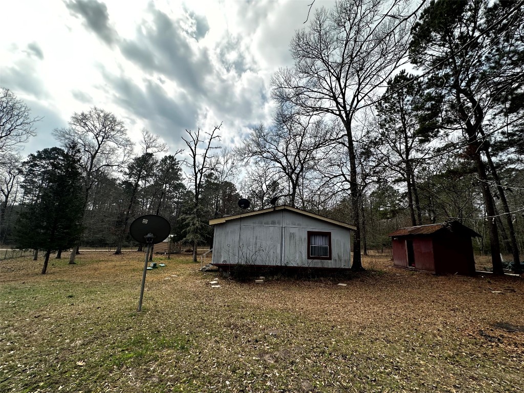 119 Cedar Frst Lane Corrigan, TX 75939 - Photo 29 of 32 a house view with a backyard space