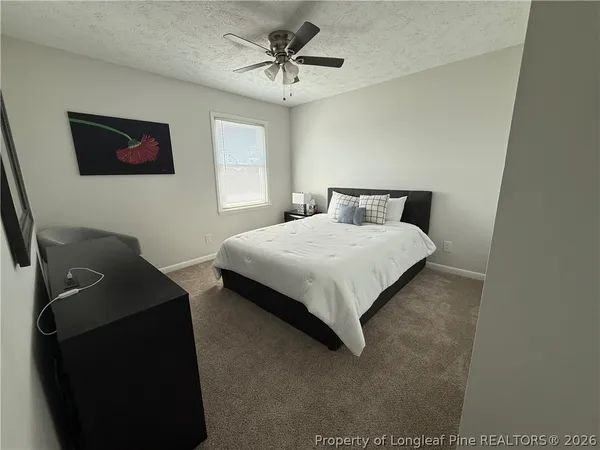 a bedroom with bed and window