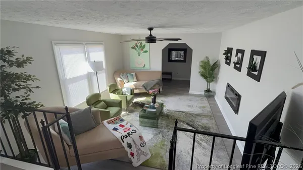 a living room with furniture and a fireplace