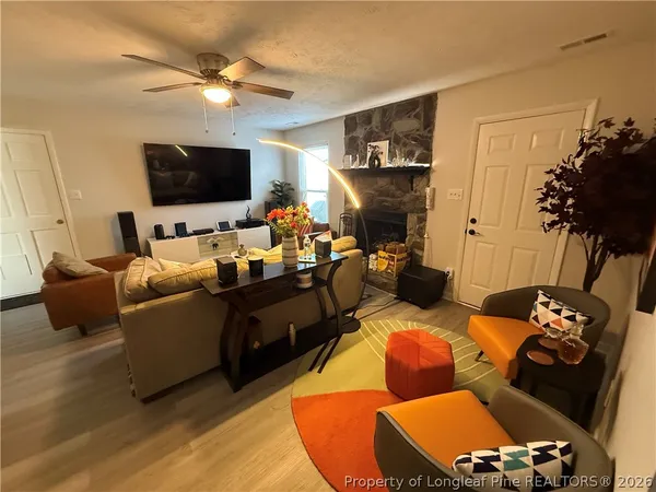 a living room with furniture and a flat screen tv