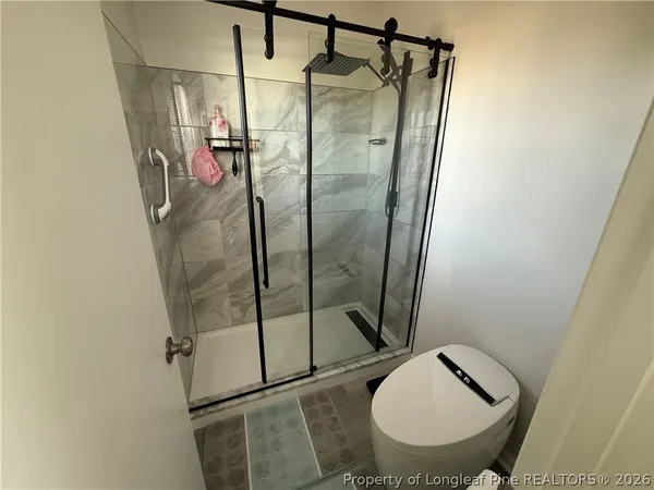 a bathroom with a shower and toilet