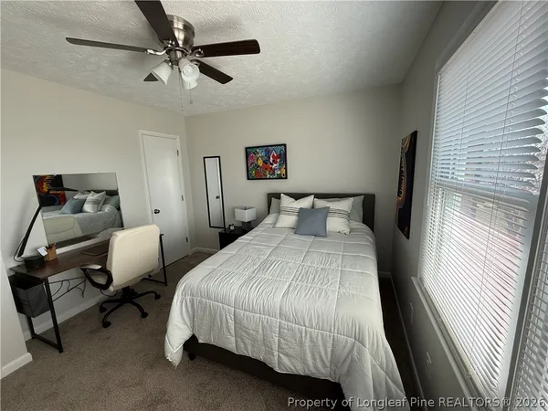 a bedroom with a bed and a chair