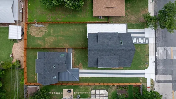 an aerial view of a house with a yard