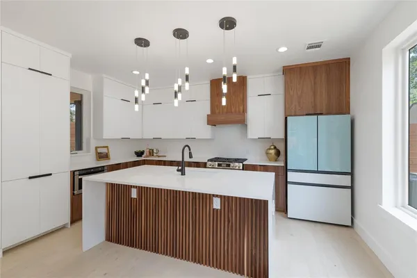 a kitchen with a sink stainless steel appliances and cabinets