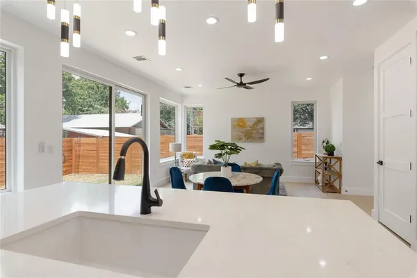 a large kitchen with kitchen island a large window in it