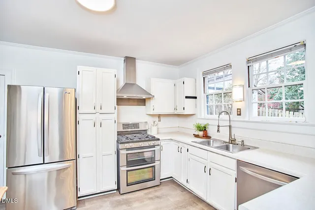 a kitchen with white cabinets and white appliances
