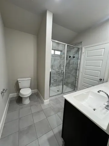a bathroom with a double vanity sink toilet and shower