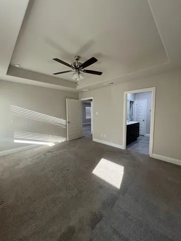 a view of a livingroom with a fireplace and a ceiling fan