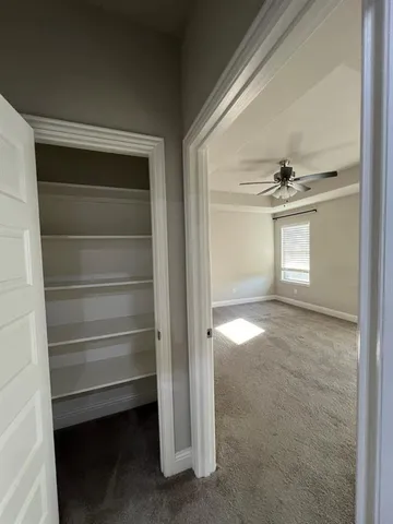 a kitchen with a refrigerator and a stove top oven