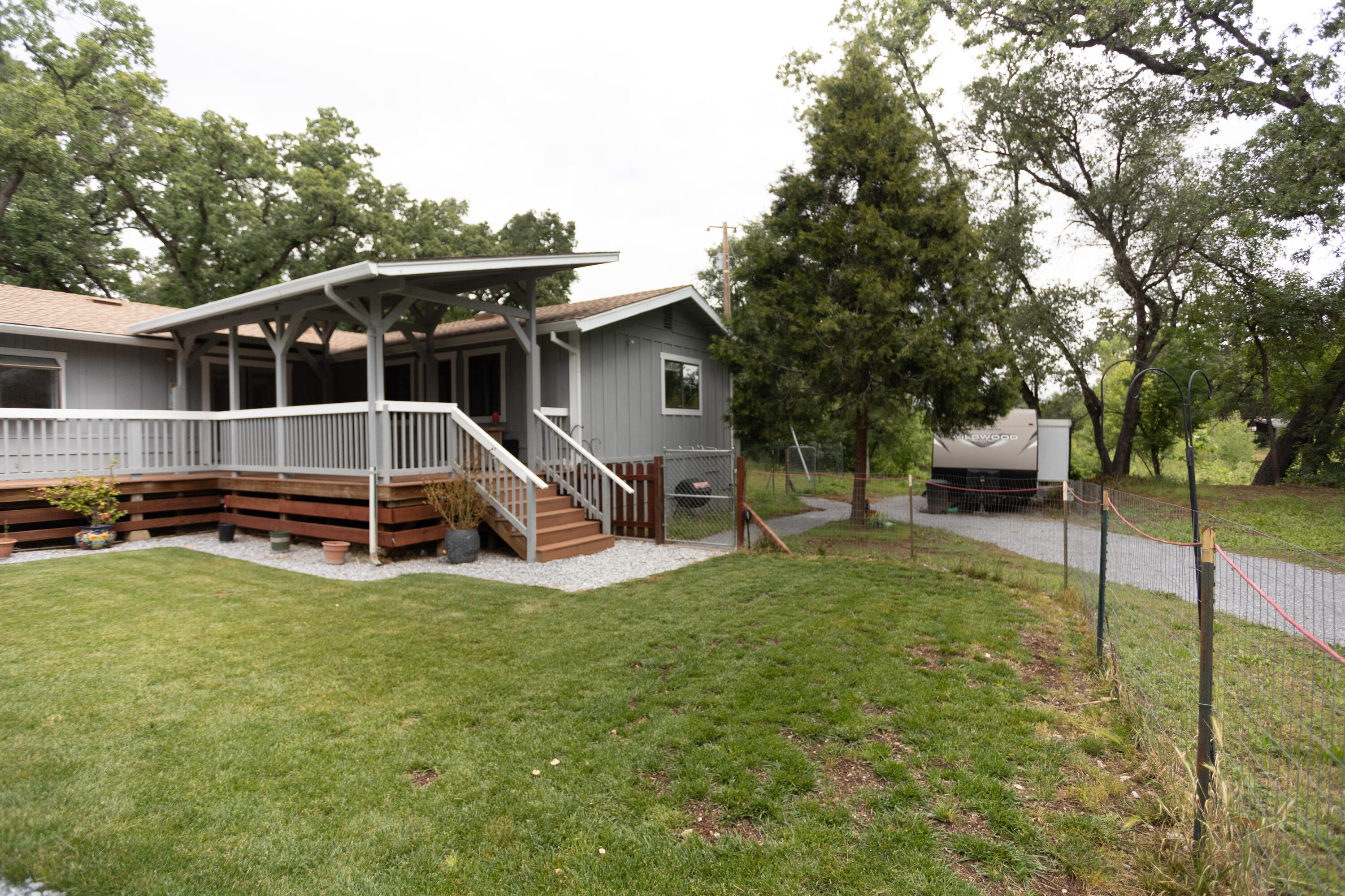 9891 Harley Leighton Road Redding, CA 96003 - Photo 15 of 52 a view of a house with backyard and trees