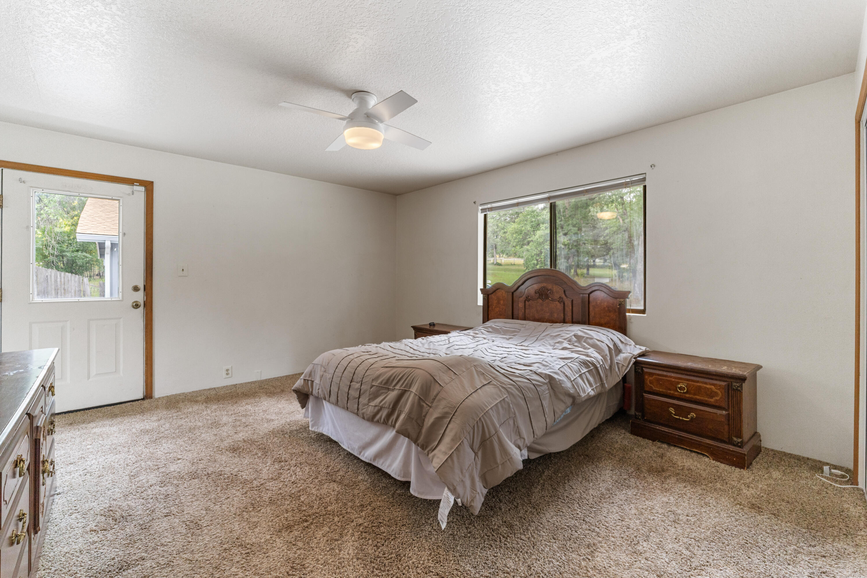 9891 Harley Leighton Road Redding, CA 96003 - Photo 37 of 52 a bed sitting in a spacious bedroom next to a window