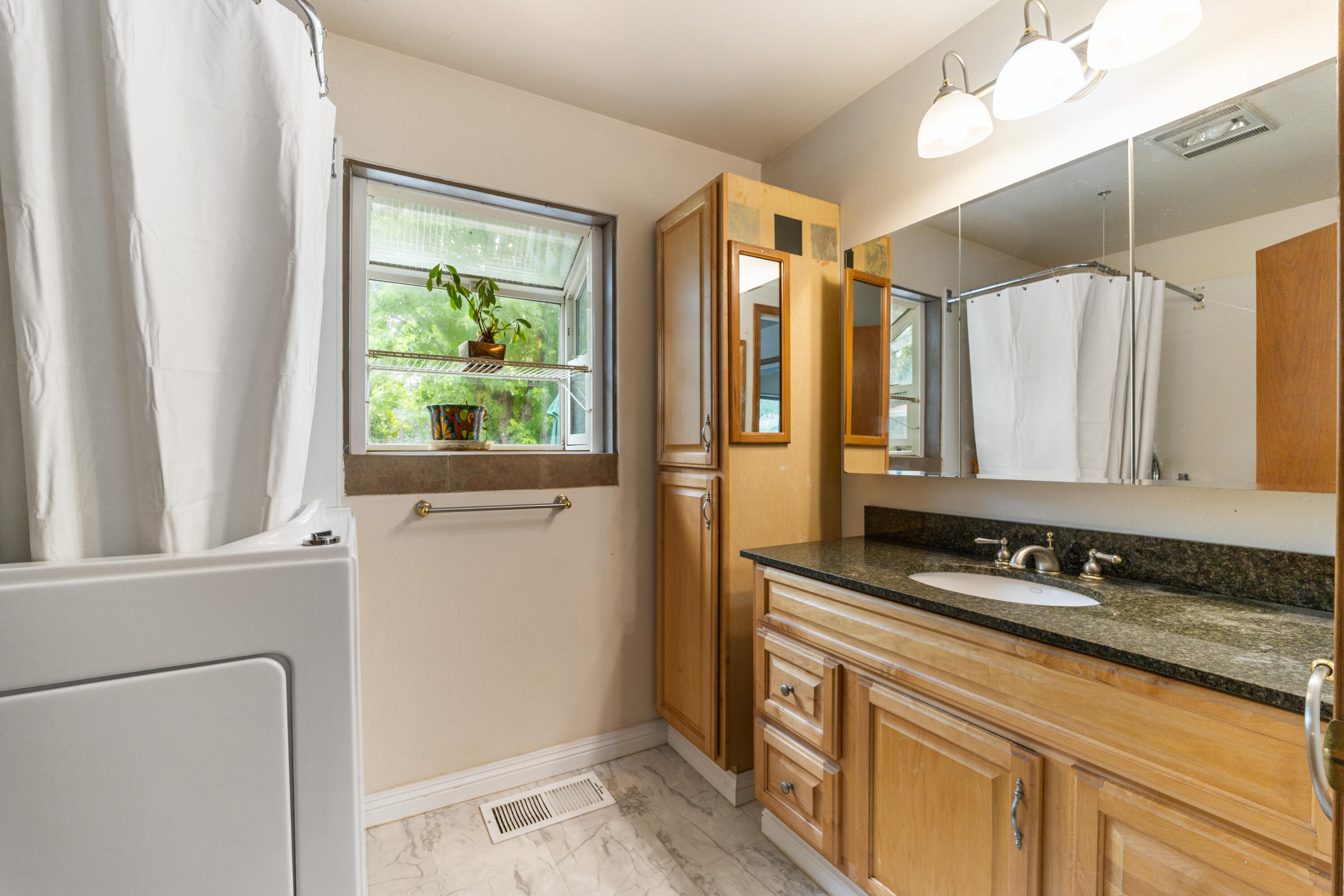 9891 Harley Leighton Road Redding, CA 96003 - Photo 39 of 52 a bathroom with a double vanity sink and a mirror