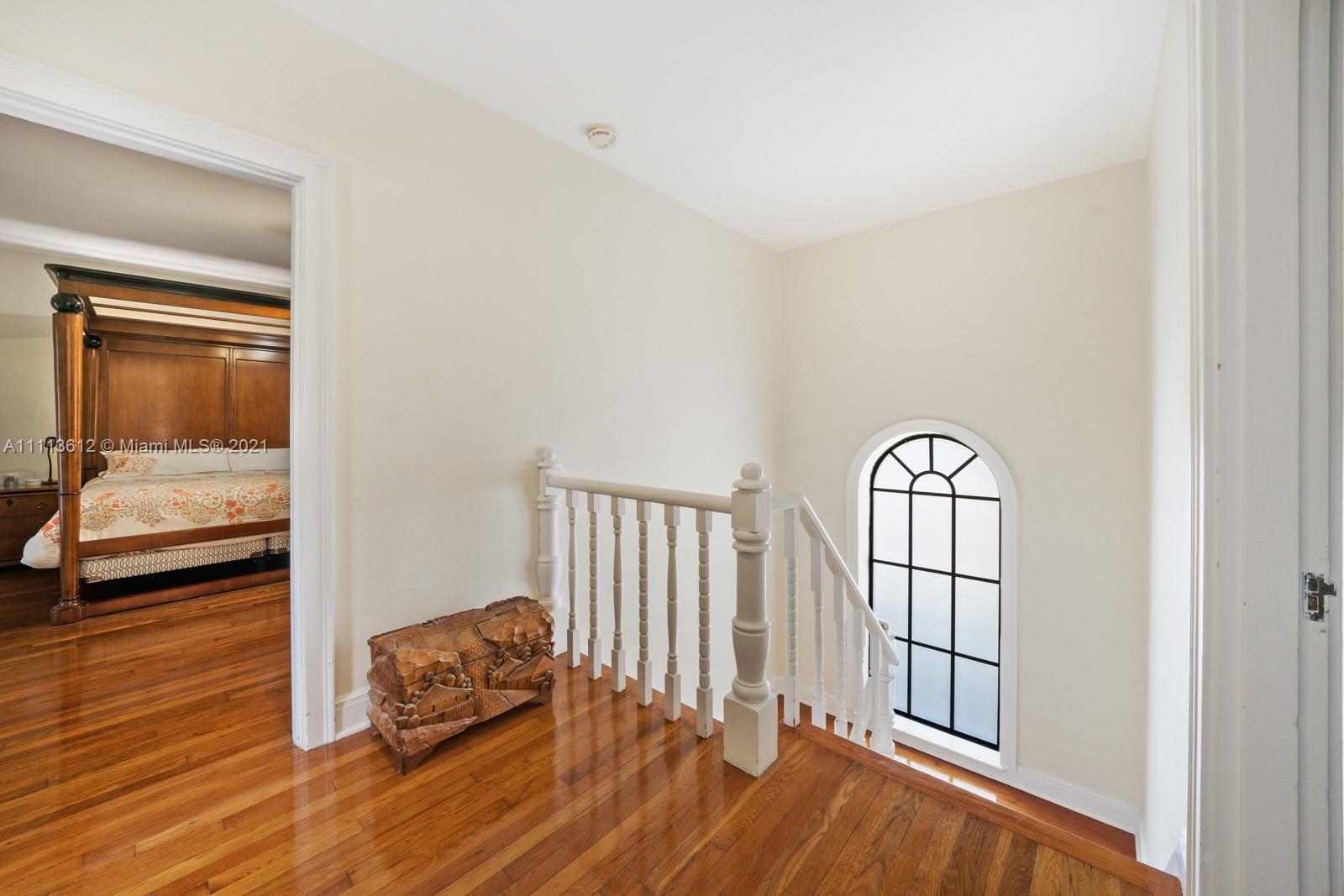 1333 Blue Road Coral Gables, FL 33146 - Photo 19 of 25 an empty room with wooden floor and windows