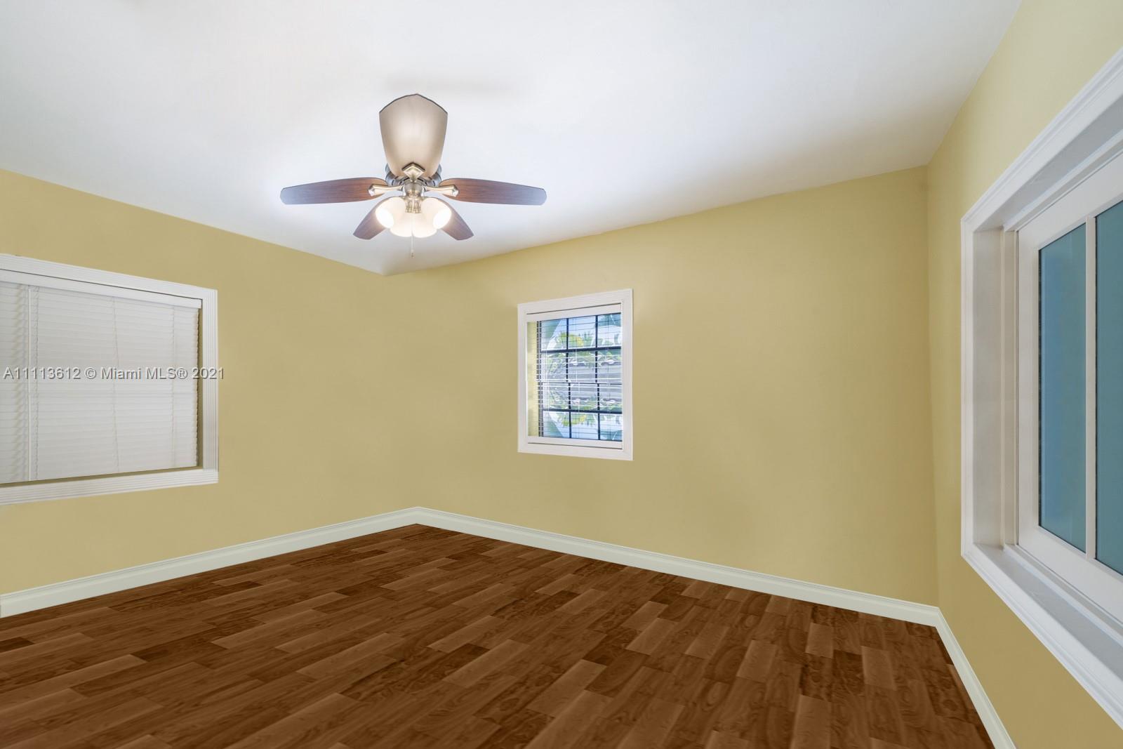 1333 Blue Road Coral Gables, FL 33146 - Photo 20 of 25 a view of an empty room with wooden floor and a window
