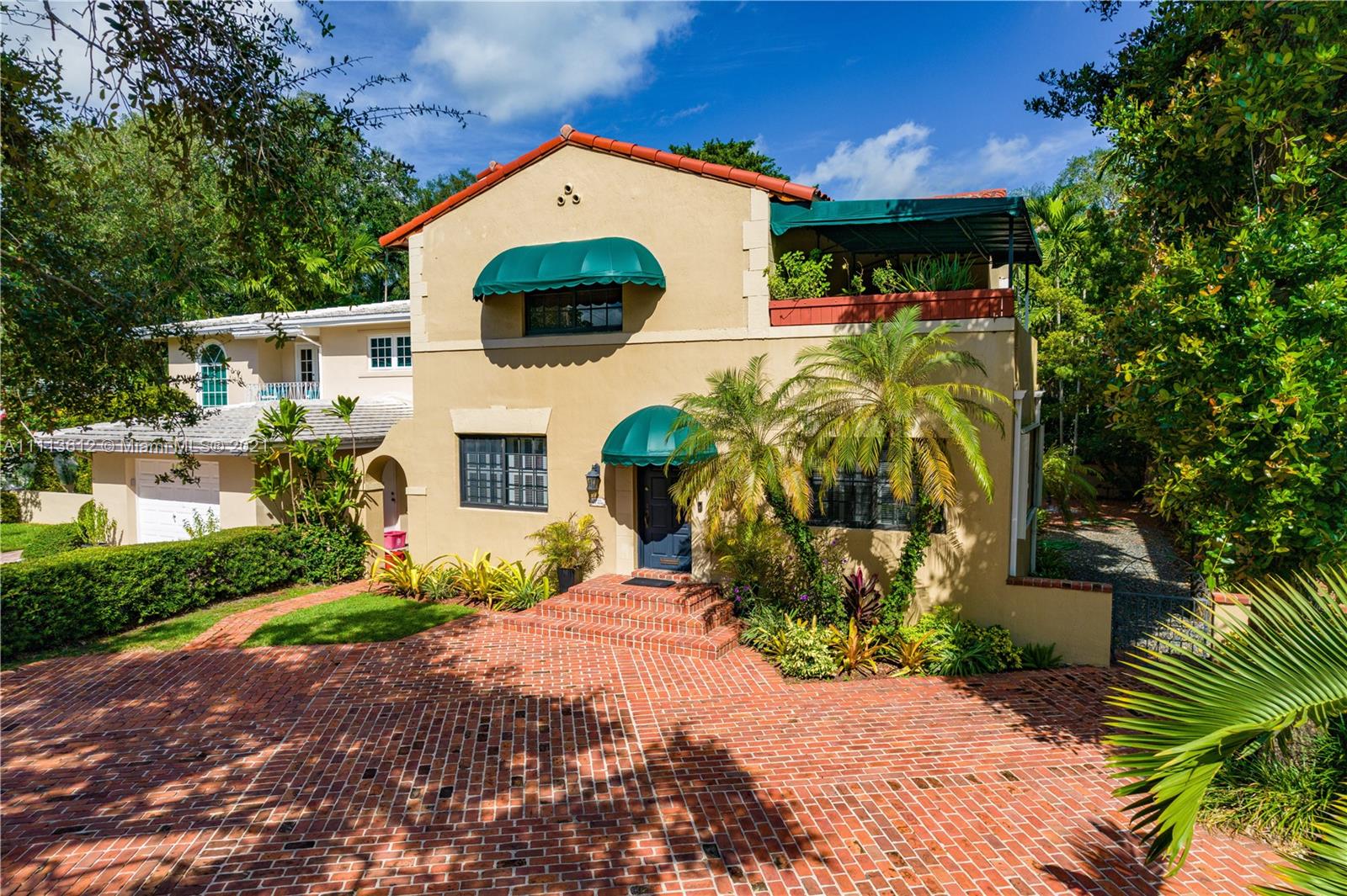 1333 Blue Road Coral Gables, FL 33146 - Photo 2 of 25 a front view of a house with a yard