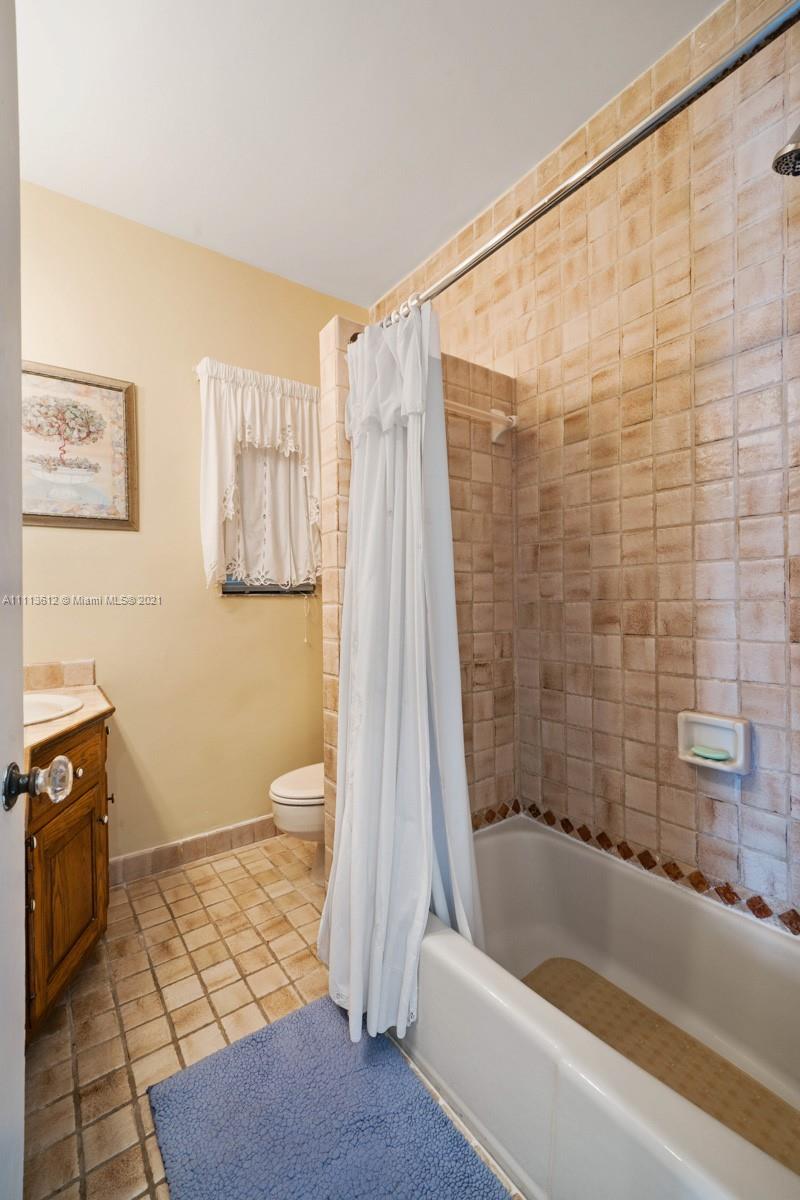 1333 Blue Road Coral Gables, FL 33146 - Photo 22 of 25 a bathroom with a bathtub and a shower
