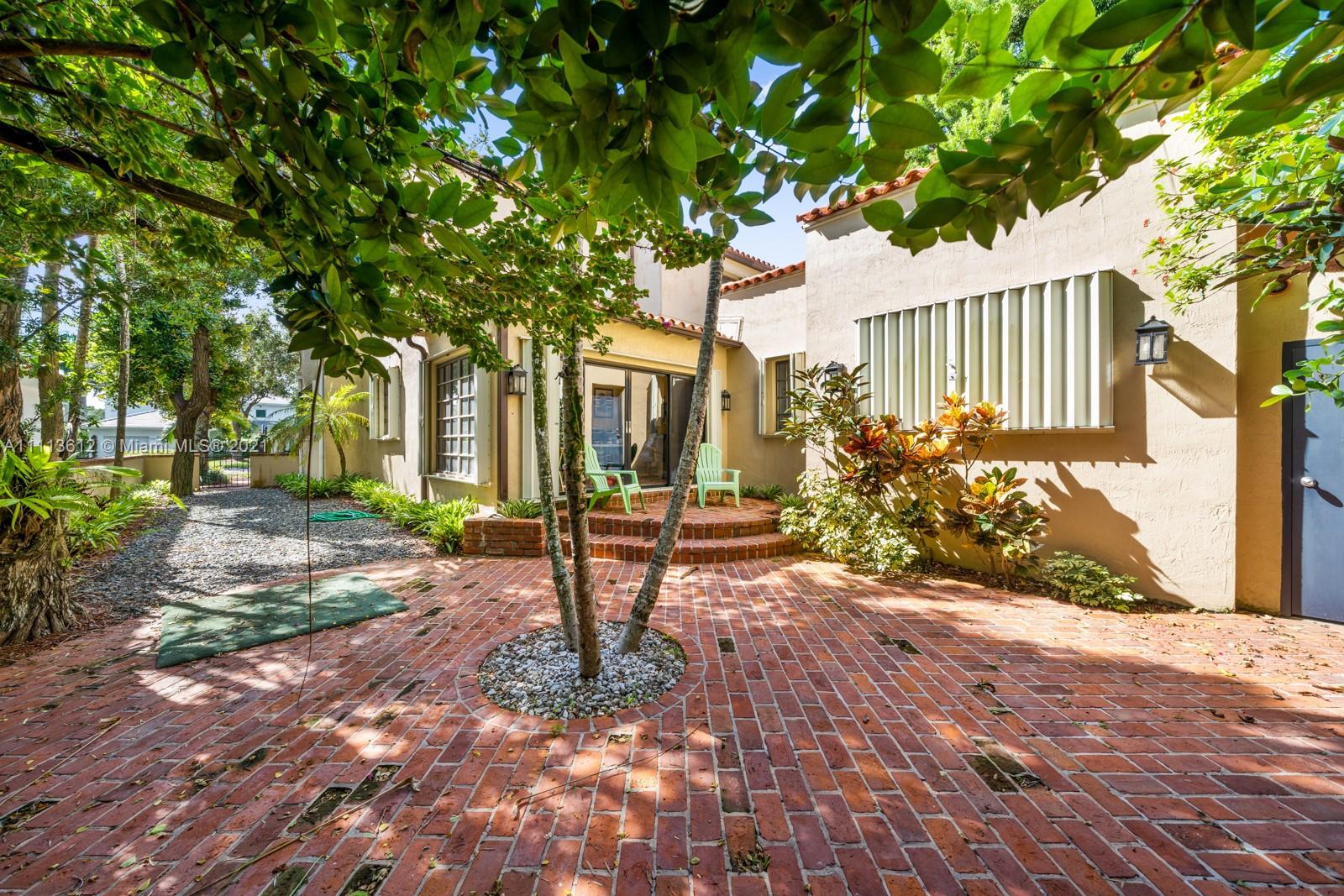 1333 Blue Road Coral Gables, FL 33146 - Photo 4 of 25 a view of a house with backyard and tree