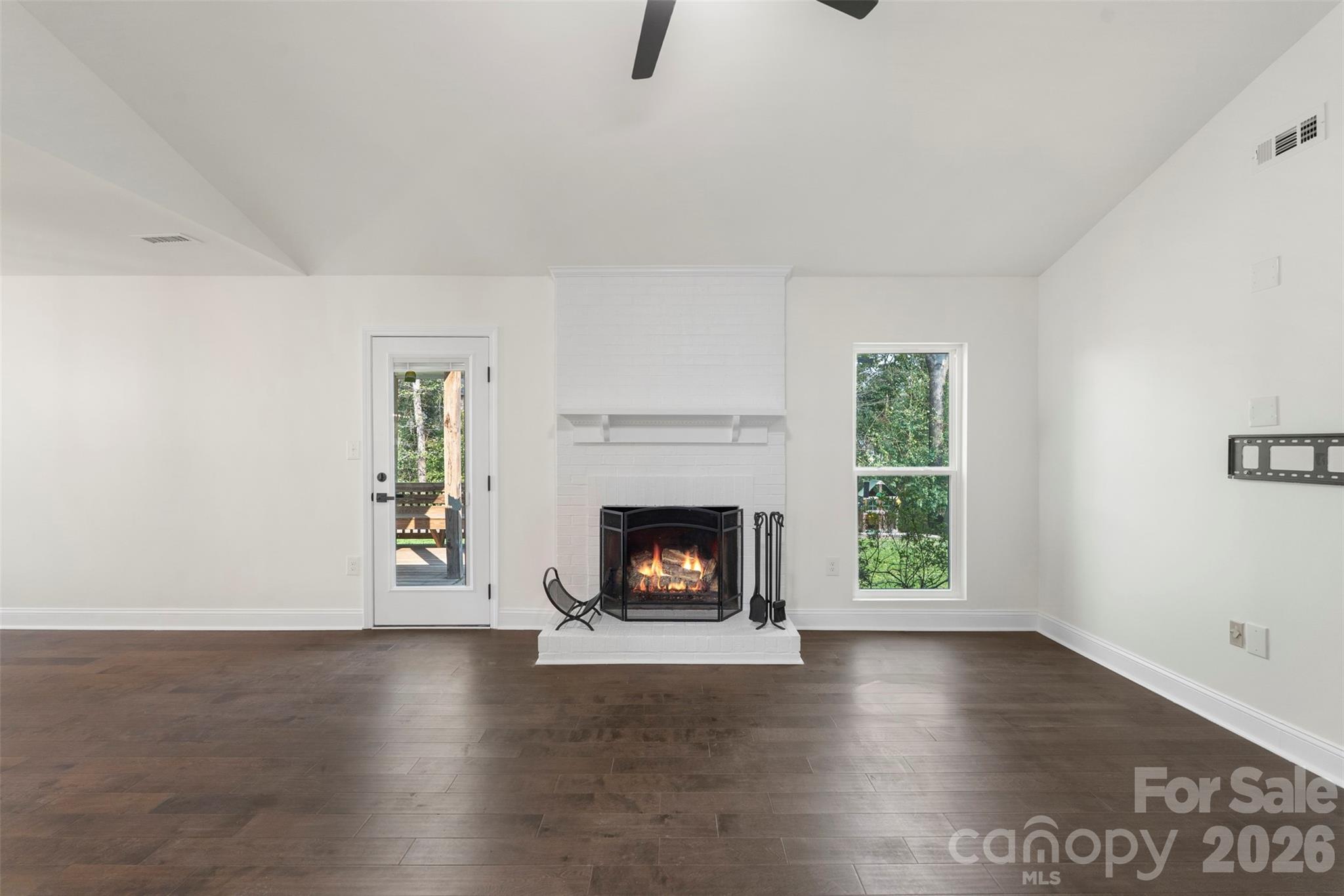 7308 Walterboro Road Charlotte, NC 28227 - Photo 12 of 43 an empty room with windows and fireplace