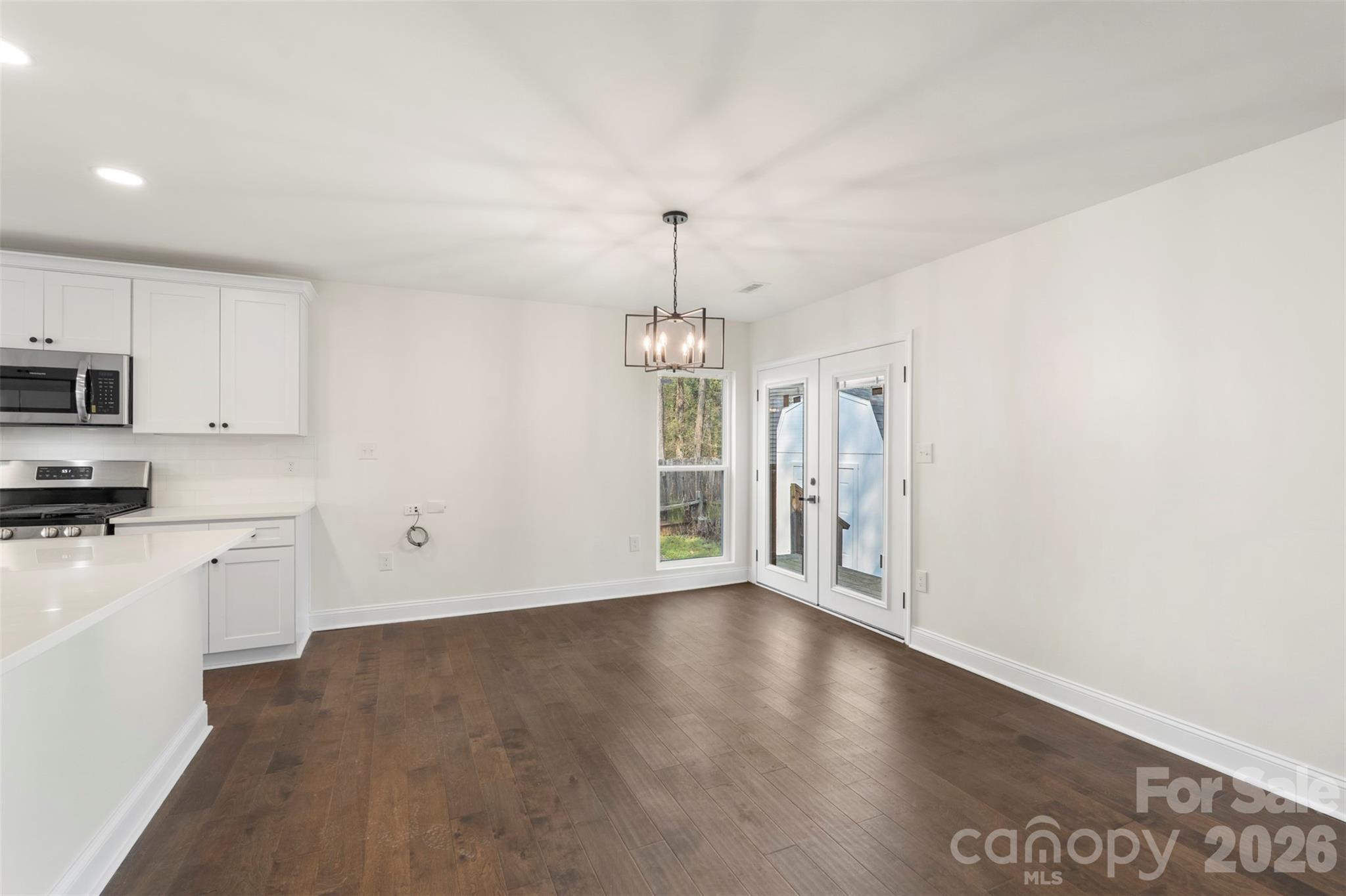 7308 Walterboro Road Charlotte, NC 28227 - Photo 13 of 43 a view of an empty room with window and wooden floor