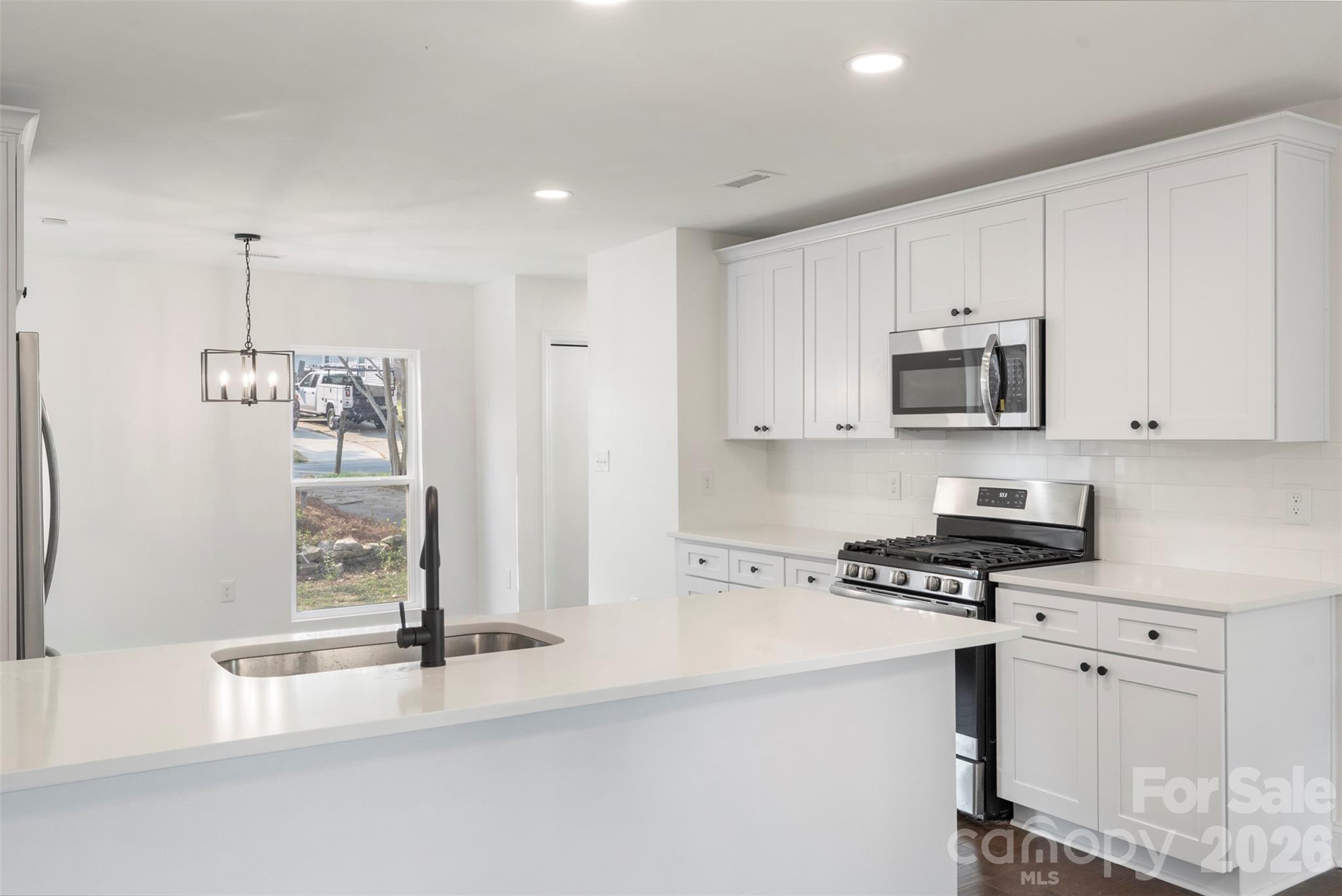 7308 Walterboro Road Charlotte, NC 28227 - Photo 15 of 43 a kitchen with stainless steel appliances granite countertop a stove a sink and a refrigerator