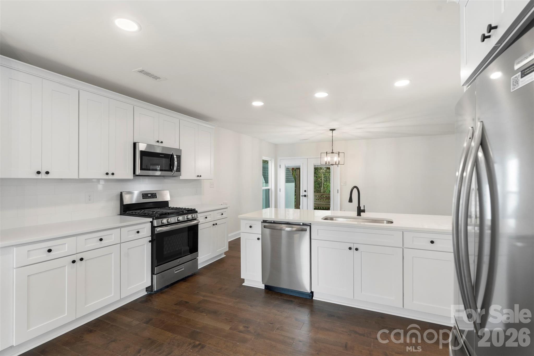 7308 Walterboro Road Charlotte, NC 28227 - Photo 18 of 43 a kitchen with stainless steel appliances granite countertop a sink stove and refrigerator