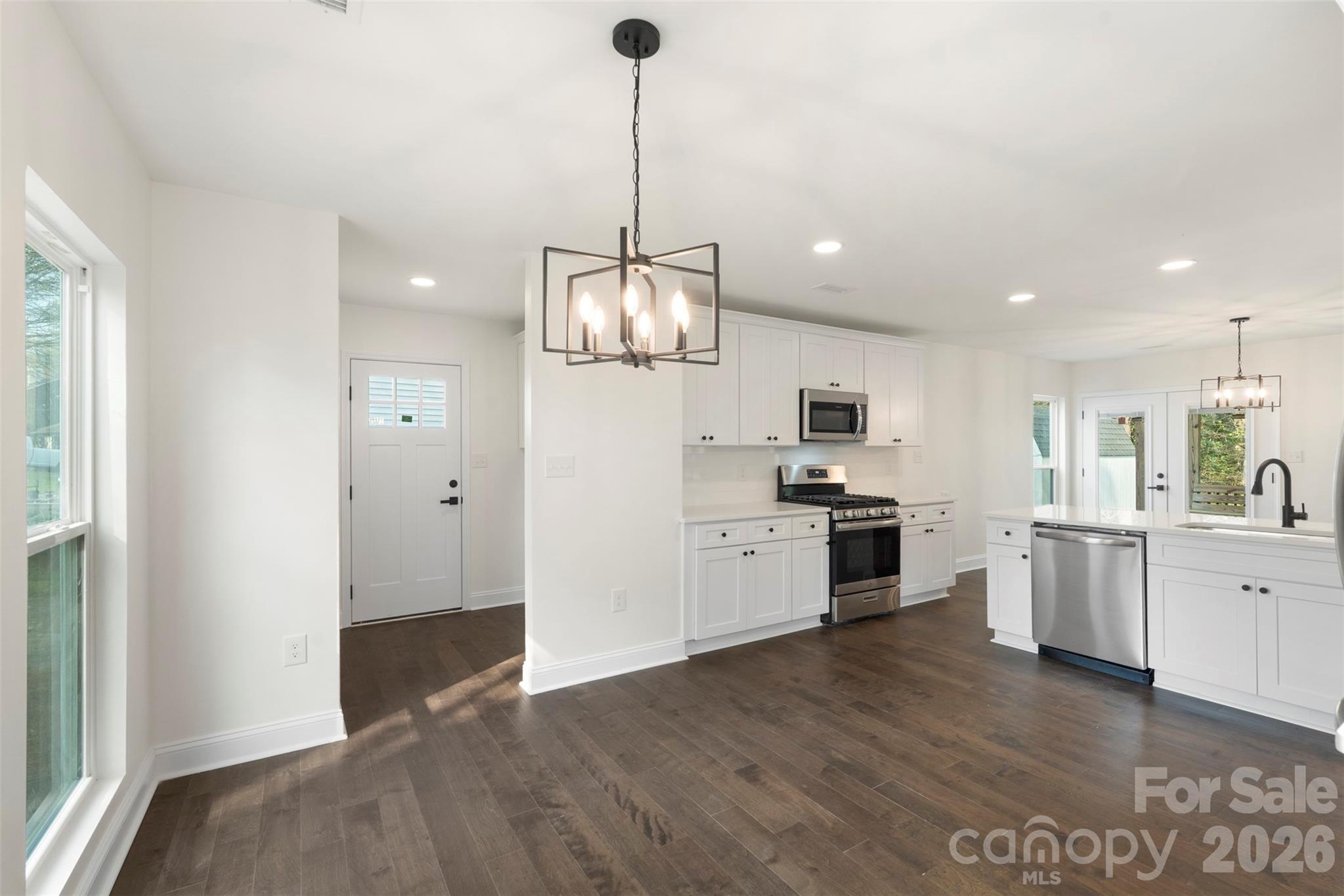 7308 Walterboro Road Charlotte, NC 28227 - Photo 20 of 43 a kitchen with white cabinets and stainless steel appliances