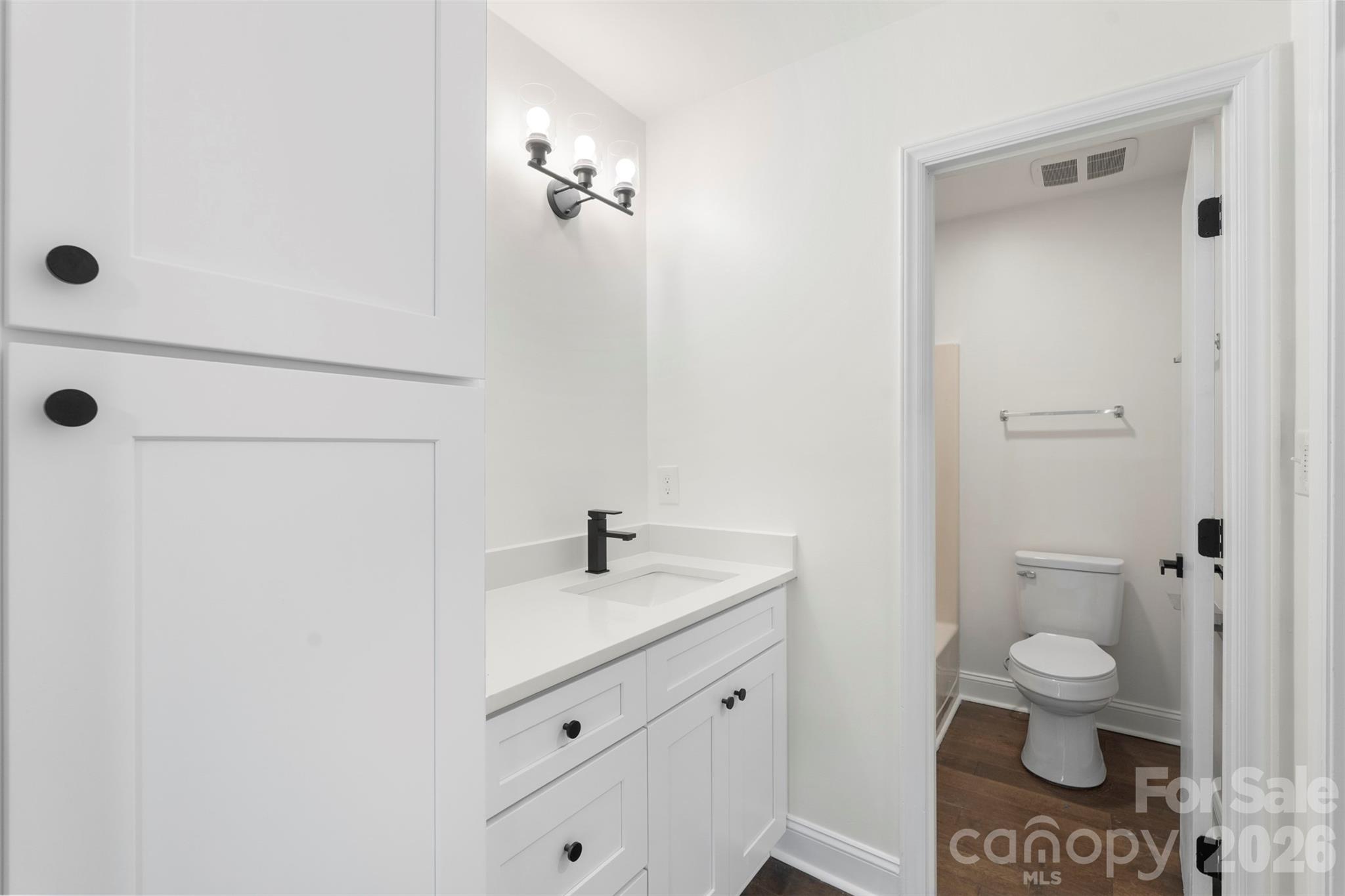 7308 Walterboro Road Charlotte, NC 28227 - Photo 25 of 43 a bathroom with a granite countertop sink a toilet and a mirror
