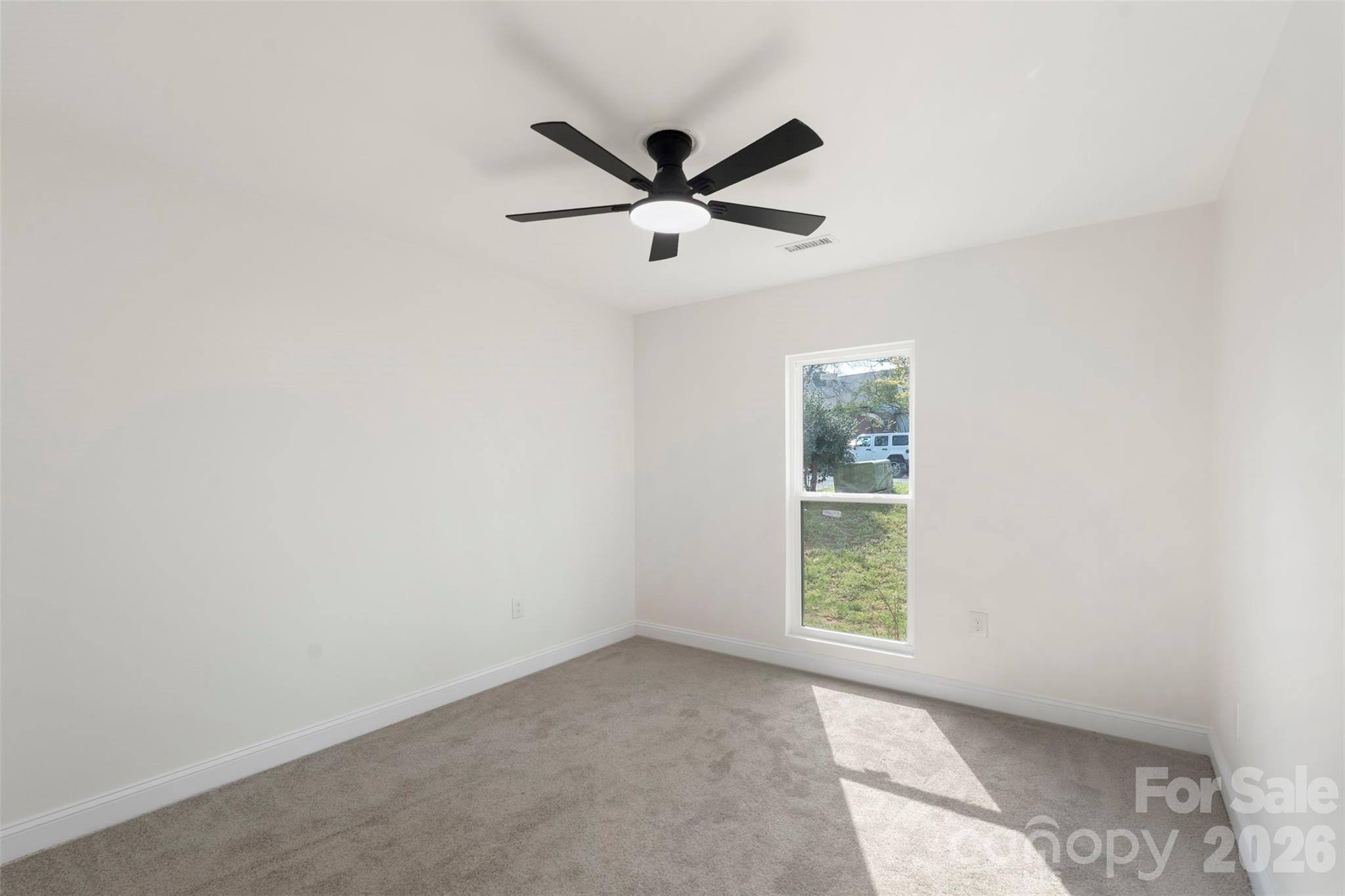7308 Walterboro Road Charlotte, NC 28227 - Photo 27 of 43 an empty room with window and ceiling fan
