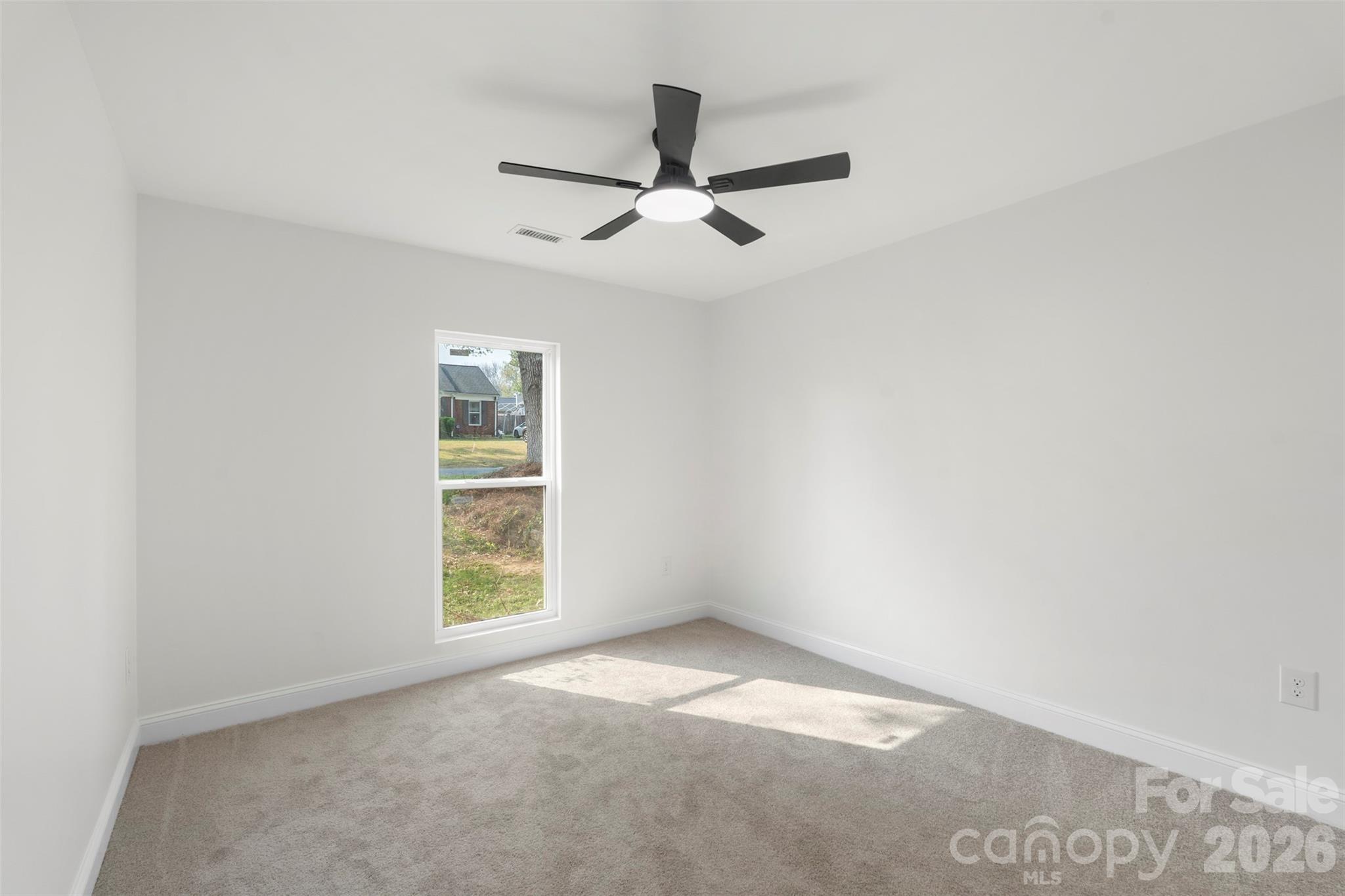 7308 Walterboro Road Charlotte, NC 28227 - Photo 29 of 43 an empty room with windows and fan