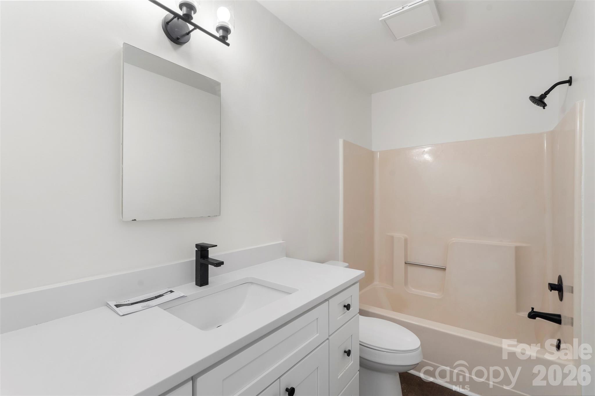 7308 Walterboro Road Charlotte, NC 28227 - Photo 31 of 43 a bathroom with a sink a toilet and shower