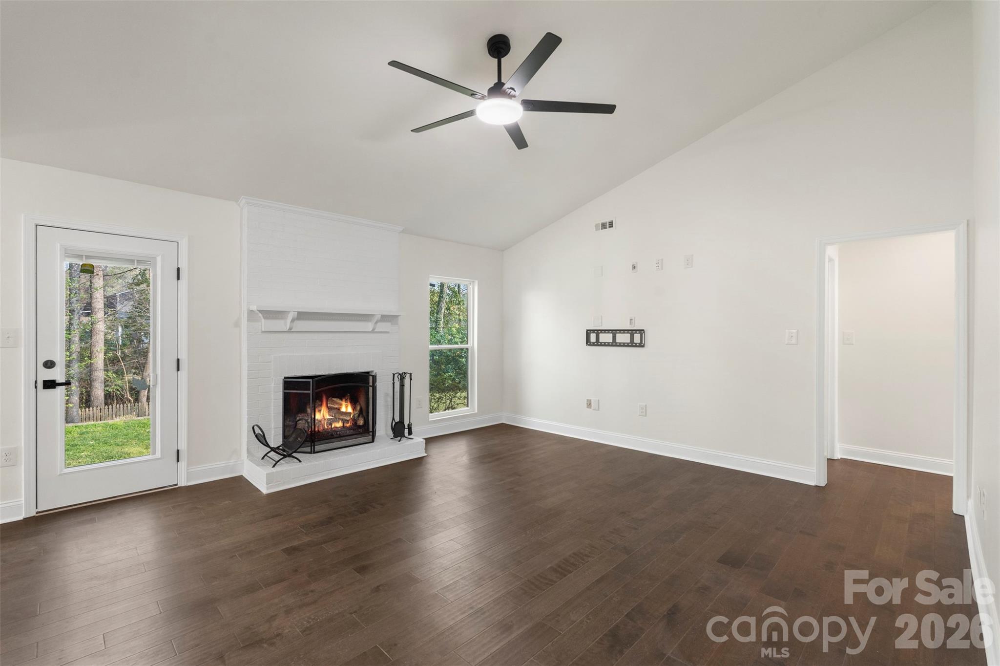 7308 Walterboro Road Charlotte, NC 28227 - Photo 7 of 43 an empty room with windows a fireplace