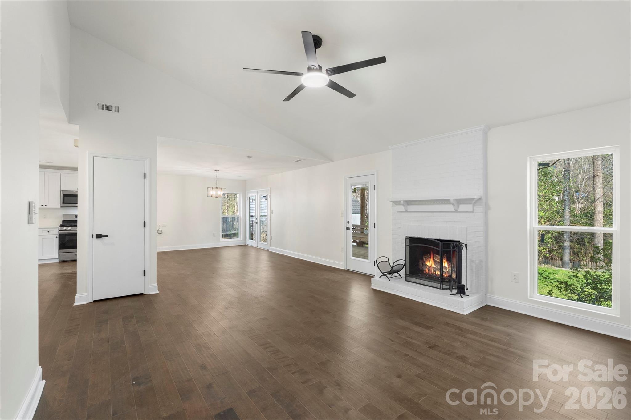 7308 Walterboro Road Charlotte, NC 28227 - Photo 9 of 43 a view of empty room with wooden floor and fireplace