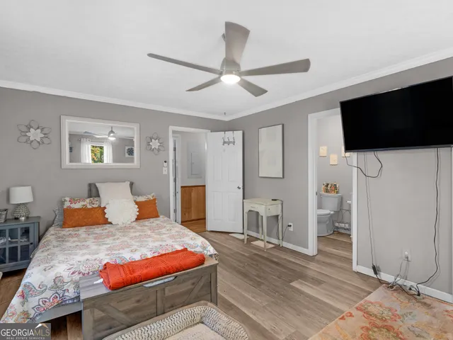 a bedroom with a large bed and a flat screen tv