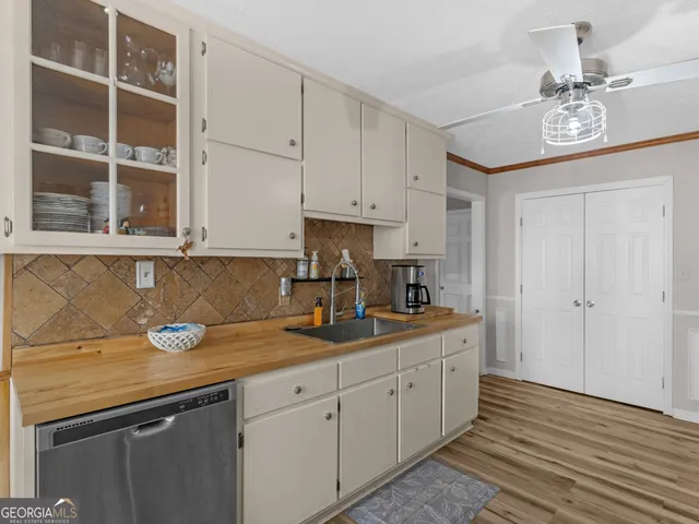 a kitchen with stainless steel appliances granite countertop a sink and cabinets