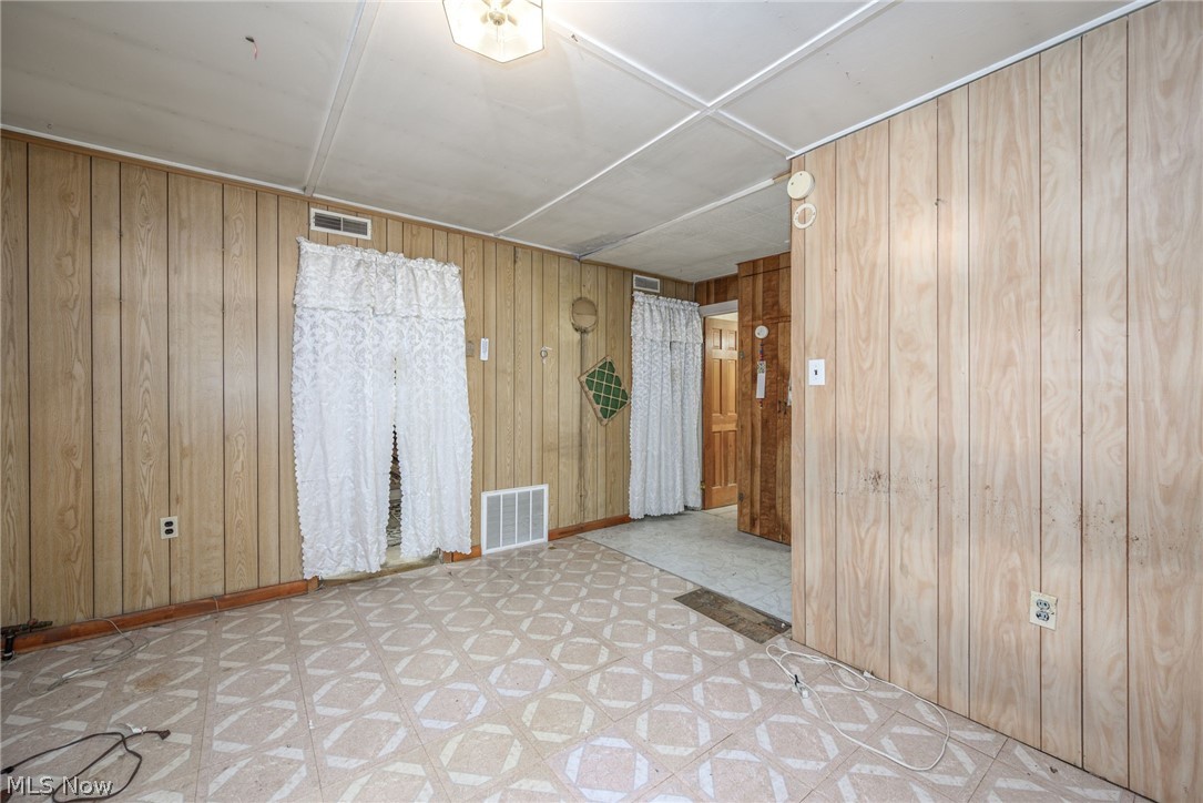 8386 Yale Road Rootstown, OH 44272 - Photo 7 of 46 Wood-finish wall paneling throughout, patterned floor tiles, and a ceiling-mounted light fixture