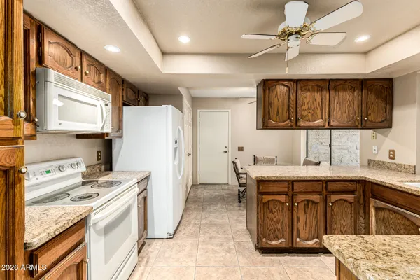a kitchen with a sink refrigerator and cabinets