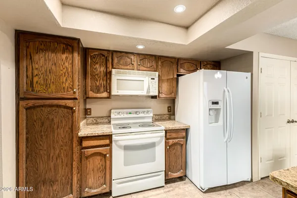 a kitchen with a refrigerator sink stove and cabinets