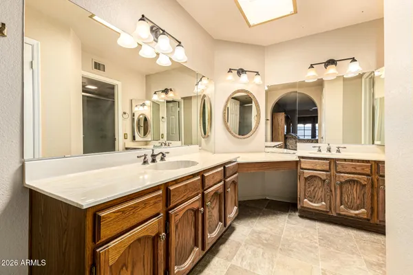 a bathroom with a sink vanity and a mirror
