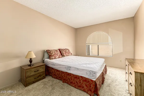a bedroom with a bed and a dresser